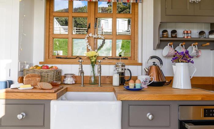 The kitchen area is cleverly designed and well equipped.  It features a Bosch hob and oven/microwave.  It also has an extractor fan and a concealed sm